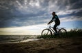 Man along the shore with the bike Royalty Free Stock Photo