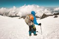 Man alpinist climbing with backpack in mountains