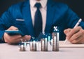 Man analyzes finance growth, stacking coins. Concept: strategic investment.Savings, male hand stacking gold coins into increasing Royalty Free Stock Photo