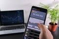 The man analyzes the schedule of changes in the price of bitcoin in the mobile application.