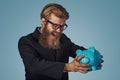 Man angry at his piggy bank trying to broke it up Royalty Free Stock Photo