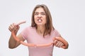 Man and angry young owan look on camera with sausage in mouth. She look on camera. Model hold set of sausages. Isolated Royalty Free Stock Photo