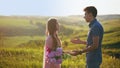 Man apologizes to the girl, the angry woman beats the guy and throws flowers at him and leaves.