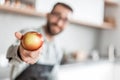 Man with an Apple sitting in the kitchen Royalty Free Stock Photo