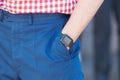 Man with Apple watch, blue trousers and red and white checkered shirt before Salvatore Ferragamo fashion show,