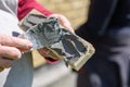 Man applies glue with spatula on decorative facing brick, view close up. Theme of construction