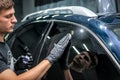 Man applies nano protective coating to the car glass