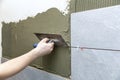 man apply tile adhesive on the wall Royalty Free Stock Photo