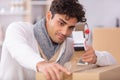 man applying adhesive tape on packing box Royalty Free Stock Photo