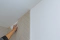 Man applying ceramic tile to a bathtub enclosure wall home repair renovation work