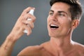 Man applying fresh breath spray Royalty Free Stock Photo