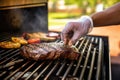 man applying marinade to a sirloin steak on the grill