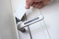 Man applying plastic card to door lock to open closeup