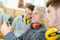 Man with apprentices holding bearing Royalty Free Stock Photo
