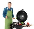 Man in apron cooking on barbecue grill