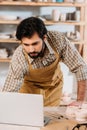 man in apron working with laptop Royalty Free Stock Photo