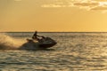 A man on an aquabike against a sunset on the sea Royalty Free Stock Photo