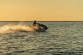 A man on an aquabike against a sunset on the sea Royalty Free Stock Photo