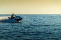 A man on an aquabike against a sunset on the sea Royalty Free Stock Photo