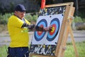 Man archer taking arrows off the target at the shooting range