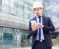 Man architect in helmet working at the tablet Royalty Free Stock Photo