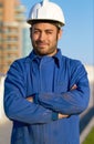 Man, architect and portrait smile in construction with arms crossed and hard hat in the city. Male person, engineer or