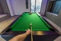 Man arm playing Snooker Pool green table in a modern games room Royalty Free Stock Photo