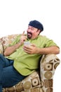 Man in armchair with mobile wagging finger