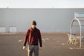 A man armed with a knife stands in the parking lot