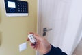 A man arming or disarming a home security alarm, Home security alarm