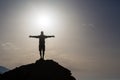 Man with arms outstretched celebrate mountains sunrise Royalty Free Stock Photo