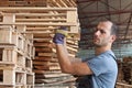 Man arraging pallets, horizontal shot