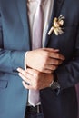 Man arranging his buttonholes Royalty Free Stock Photo
