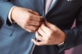 Man arranging his buttonholes Royalty Free Stock Photo