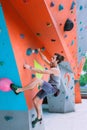 Man on artificial exercise climbing wall Royalty Free Stock Photo
