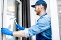 Man as a professional cleaner washing window Royalty Free Stock Photo