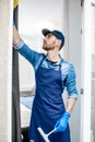 Man as a professional cleaner washing window Royalty Free Stock Photo