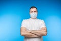 Man in aseptic mask with folded arms. Royalty Free Stock Photo