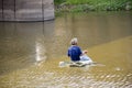 Man asia local fisher working by cast a net in canal