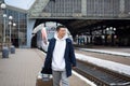 Man asian passenger arrives in nome town, with big suitcase, tourist at train station
