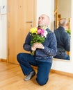 Man asks forgiveness with flowers. Royalty Free Stock Photo