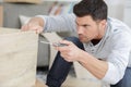 Man assembles furniture wardrobe Royalty Free Stock Photo