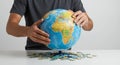 A man assembles a model of the globe from puzzles