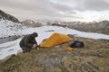 A man assembles a tunnel tent