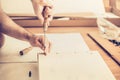 Man assembles wardrobe, twists the screws the slots, furniture assembly