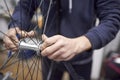 Man assembling a bike wheel axle after the process of cleaning and greasing Royalty Free Stock Photo