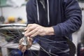 Man assembling a bike wheel axle after the process of cleaning and greasing