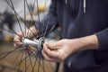 Man assembling a bike wheel axle after the process of cleaning and greasing Royalty Free Stock Photo