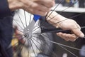 Man assembling a bike wheel axle after the process of cleaning and greasing Royalty Free Stock Photo