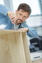 man assembling furniture from chipboard boards Royalty Free Stock Photo